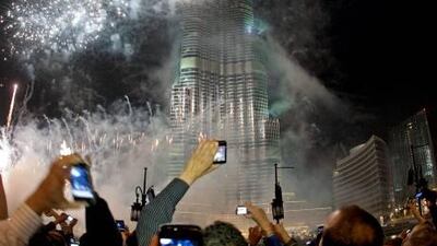 Spectators photograph the fireworks at the Burj Khalifa on New Year’s Eve in Dubai last year. Jeff Topping / The National