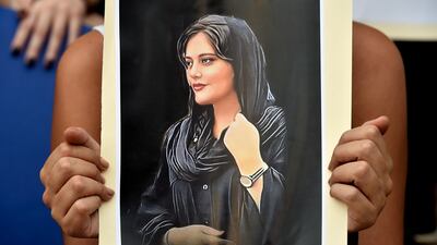 A Lebanese activist holds a poster depicting Amini during a protest in Beirut organised by feminist groups in support of women protesters in Iran. EPA