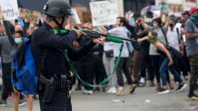 A police officer prepares to fire rubber bullets during a protest in Los Angeles. AP Photo