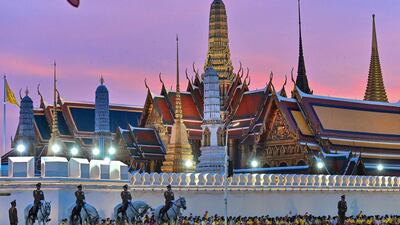 Royalist supporters wait to catch a glimpse of Thailand's King Maha Vajiralongkorn as he heads to the Grand Palace for a Buddhist ceremony for the late king Chulalongkorn in Bangkok. AFP
