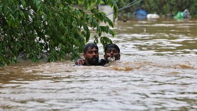 A man rescues a drowning man on the outskirts of Kochi. Reuters