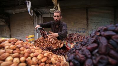 A man in Peshawar, Pakistan, sells date palms, a popular appetiser for breaking the fast during Ramadan. EPA