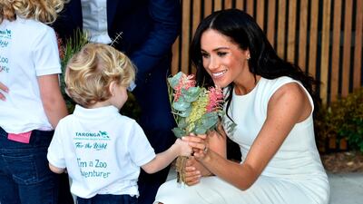 Meghan receives native flowers from 4-year-old Findlay Blue after she and Prince Harry officially opened the Taronga Institute of Science and Learning at Taronga Zoo in Sydney. AP Photo
