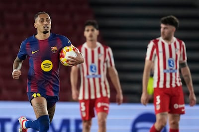Raphinha runs with the ball back to the halfway line after giving Barcelona a 2-0 lead against Atletico Madrid. EPA