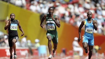 The UAE's Omar Juma al Salfa, left, races Nigeria's Obinna Metu and the Bahamas' Jamaal Rolle in a 200m heat at the Beijing Olympics.