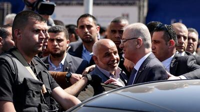 Palestinian Prime Minister Rami Hamdallah (second right) is greeted by Hamas' security chief Tawfiq Abu Naim (cente) upon his arrival in Gaza City on March 13, 2018. Mahmud Hams / FP