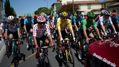 Tadej Pogacar, in yellow, Nairo Quintana, in the best climber's dotted jersey and Mark Cavendish, in the best sprinter's green jersey before the start of Stage 11.