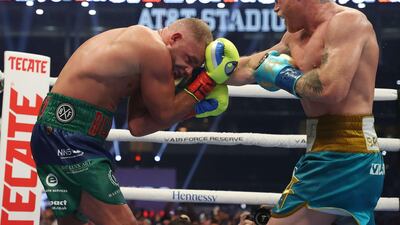 Saul Alvarez lands a punch on Billy Joe Saunders during their super middleweight title fight at AT&T Stadium. AFP