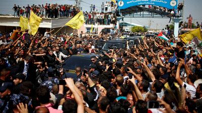 People gather as the convoy of Palestinian Prime Minister Rami Hamdallah and his government ministers arrive to take control of Gaza from the Islamist Hamas group, in the northern Gaza Strip October 2, 2017.