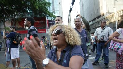 People shout slogans against Venezuela's President Nicolas Maduro during a blackout in Caracas, Venezuela. AP Photo