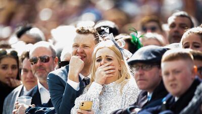 A crowd watches as a horse falls and dies in front of the main stand during Grand National Day at the Randox Grand National Festival at Aintree, UK. EPA