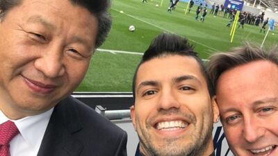 Manchester City striker Sergio Aguero takes a selfie with Chinese President Xi Jinping and former British Prime Minister David Cameron during a visit to the club's academy in 2015.