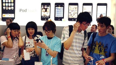 People browse Apple Inc. products at the Apple store in Beijing, China, on Saturday, July 19, 2008. Apple Inc., who is expected to release earnings on July 21, opened its first company-owned retail outlet in China today. Photographer: David Butow/Bloomberg News