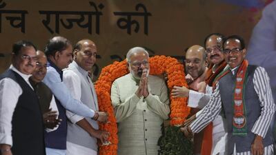 Narendra Modi is garlanded during a reception at the BJP headquarters in New Delhi a day after the party won in key state legislature elections. AP Photo
