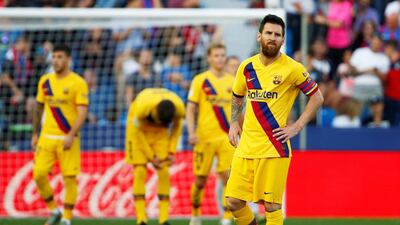 Barcelona's Lionel Messi looks dejected after Levante's Nemanja Radoja scored his team's third goal in Valencia. Reuters