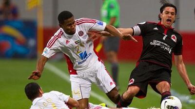 Fabio Cesar, right, of Al Rayyan finds himself outnumbered as he faces a double-team effort from Al Jazira's Subait, left, Khater and Salem.