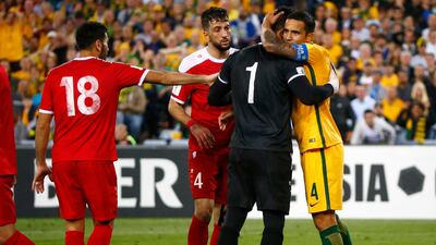 Australia veteran Tim Cahill embraces Syria's Ibrahim Alma after the play-offs. David Gray / Reuters