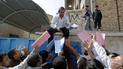 Iraq's unemployment rate is among the highest in the Middle East at 16 per cent. Above, an employment centre worker receives files from residents seeking jobs in Basra. Atef Hassan / Reuters