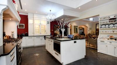 The villa’s old-money ambience is through out the house with Italian marble floors, thick mahogany staircases and a black slate floor on a Regency styled kitchen replete with Miele fixtures. Courtesy Knight Frank