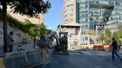 epa07848690 A bobcat works to remove the cement barrier to re-open a part of the street in front of the United Nations Building (ESCWA) in downtown Beirut, Lebanon, 17 September 2019. Roads around a United Nations Building (ESCWA) in Beirut were closed on 11 October 2011 as part of measures to protect the building following a series of attacks on the United Nations. EPA/WAEL HAMZEH