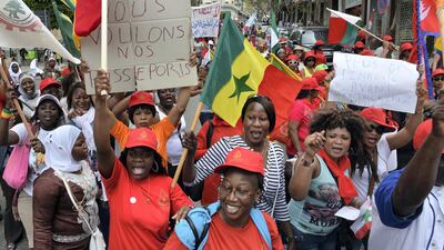 Migrant domestic workers carry placards with slogans such as: 'We want our passports' and flags during a demonstration in Beirut, Lebanon, on May 3, 2015. Wael Hamzeh / EPA