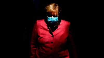 German Chancellor Angela Merkel wears a face mask as she arrives for a session of the German lower house of parliament Bundestag in Berlin. AFP