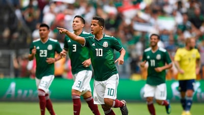 18 Mexico || The look: The first of Adidas' bespoke kits to rank high, Mexico's green shirts, white shorts and red socks flirts safely between it's traditional look and modern detailing. || Would I wear it? Yes || Photo: Alfredo Estrella / AFP Photo