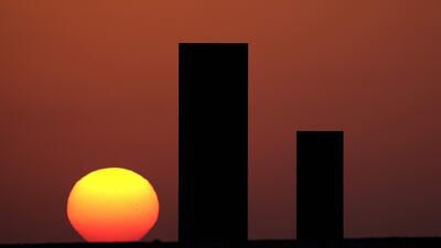 A general view shows the "East-West/West-East" sculpture by American artist Richard Serra during sunset in Qatar's Dukhan desert, west of the capital Doha, on October 9, 2022. (Photo by Ivan PISARENKO / AFP)