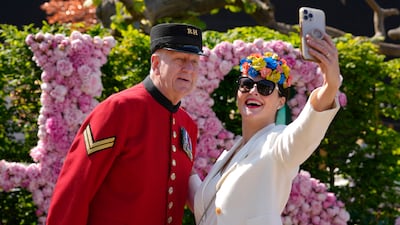 A visitor takes a selfie with Chelsea Pensioner. AP