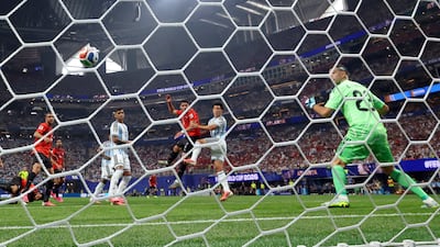 Egypt's Yasser Ibrahim heads past Argentina goalkeeper Emiliano Martínez to open the scoring. Reuters