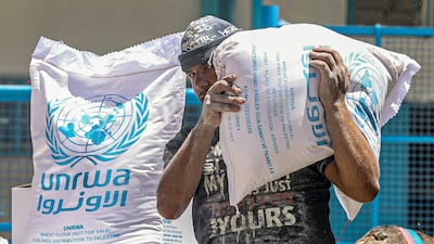 Palestinians receive rations from the UNRWA warehouse in Khan Younis in the southern Gaza Strip. AFP