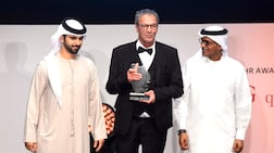 Palestinian actor and filmmaker Mohammad Bakri, centre, at Dubai International Film Festival in 2017 with Sheikh Mansoor bin Mohammed, left, and festival director Masoud Amralla Al Ali. AFP