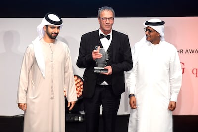 Palestinian actor and filmmaker Mohammad Bakri, centre, at Dubai International Film Festival in 2017 with Sheikh Mansoor bin Mohammed, left, and festival director Masoud Amralla Al Ali. AFP