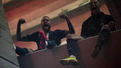 Neymar and Kylian Mbappe celebrate as fans gather outside the stadium. AFP