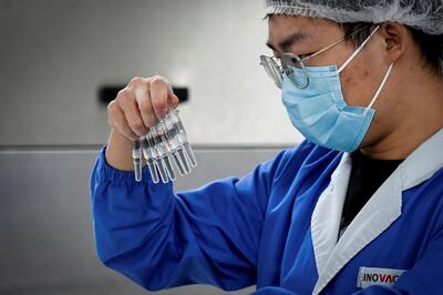 A staff member checking vaccines during a media tour of a new Sinovac factory built to produce coronavirus vaccines. AFP