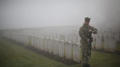 A soldier of The 2nd Battalion The Royal Regiment of Scotland presents arms among World War One headstones in Loos British Cemetery during a rehearsal for a reburial ceremony. Almost 100 years after they were killed in action in the World War One battle of Loos in 1915, twenty British soldiers will be reinterred in the Commonwealth War Graves Commission Loos British Cemetery in Northern France. Private William McAleer, from the 7th Battalion the Royal Scottish Fusiliers, was found with his identity disc, but others found with him remain unidentified and will be buried as soldiers Known unto God. Peter Macdiarmid / Getty Images