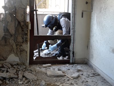 A UN expert collects samples for a chemical weapons investigation in Eastern Ghouta, Damascus. AFP