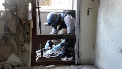 A UN weapons expert collects samples on August 29, 2013, during an investigation into a suspected chemical weapons strike near Damascus. AFP