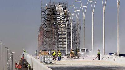 Construction workers build a project on King Abdullah Road in Riyadh in February. Fahad Shadeed / Reuters
