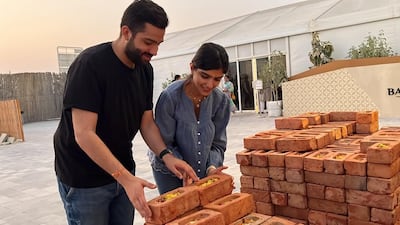 The couple laying bricks at Baps Mandir before it opened. Photo: Kanjani Family