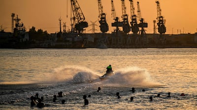 People cool off in the water near the port of Basra during a heatwave in Iraq, one of the countries that could face an economic hit due to climate change. AFP