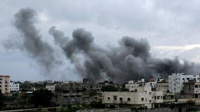 Smoke billows from a mosque following an Israeli air raid in Gaza City in the Gaza Strip. Israel continued airstrikes within the Hamas-ruled Gaza Strip for the fifth day, rebuffing any temporary truce.