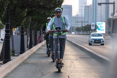 E-scooter riders on the Corniche in Abu Dhabi. Victor Besa / The National