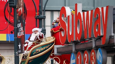 Santa Claus waves to people on the street at the conclusion of the parade. EPA