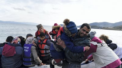 Refugees and migrants arrive with a dinghy at the village of Skala Sikaminias, on the Greek island of Lesbos, after crossing the Aegean sea from Turkey. AP