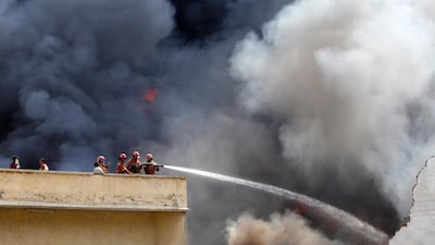 Firefighters work to put out a blaze in a warehouse of the United Nations High Commissioner for Refugees (UNHCR) in Peshawar, July 8, 2012. The cause behind the fire is unknown. No casualties were reported, according to local media. REUTERS/Fayaz Aziz