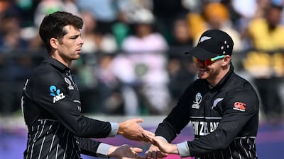New Zealand's Mitchell Santner, left, celebrates with teammate Glenn Phillips after taking the wicket of Australia's Mitchell Marsh. AFP