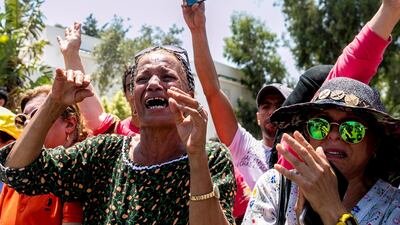 People react as the convoy carrying the body of Tunisian president Beji Caid Essebsi arrives at the presidential palace in Carthage, near Tunis, on July 26, 2019. AP Photo