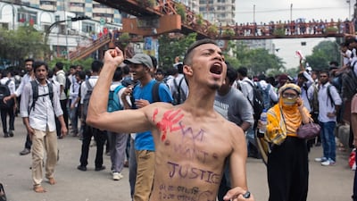 A Bangladeshi student shout slogans while blocking a road with others during a rally demanding safe roads on the seventh consecutive day of protests, in Dhaka city, Bangladesh. EPA / MONIRUL ALAM