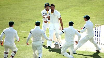 Mitchell Johnson of Australia celebrates the wicket of Ahmed Shehzad of Pakistan during Day 1 of the first Test in Dubai on Wednesday. Warren Little / Getty Images